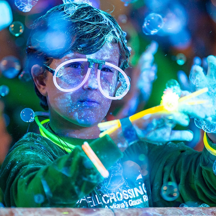 kid playing at Camelia Crossing Gleaux Run