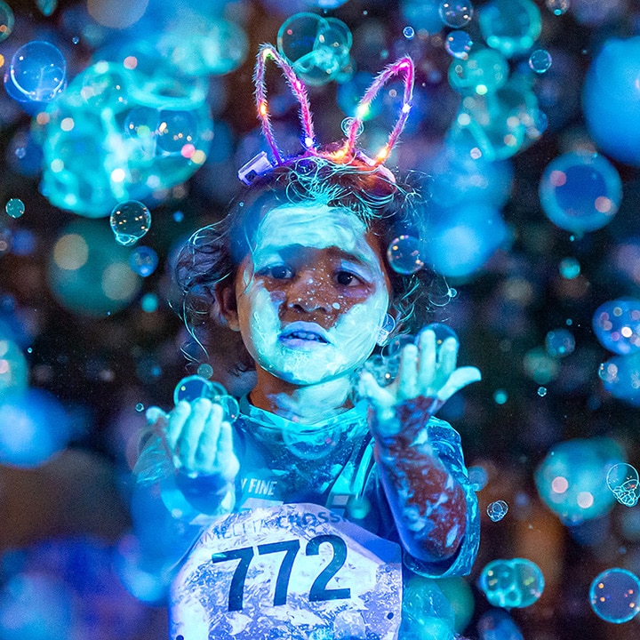 kid playing at Camelia Crossing Gleaux Run